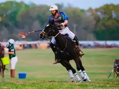 Dr. Patrick riding his horse, Joker, playing polocrosse