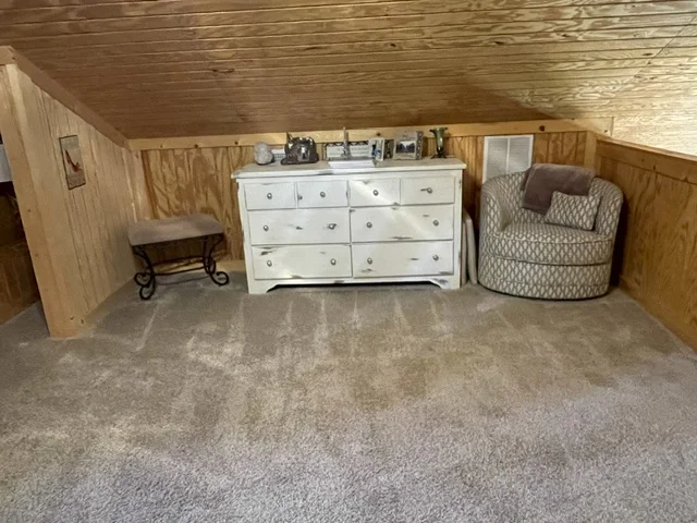 Carpet, decorated dresser, and seating